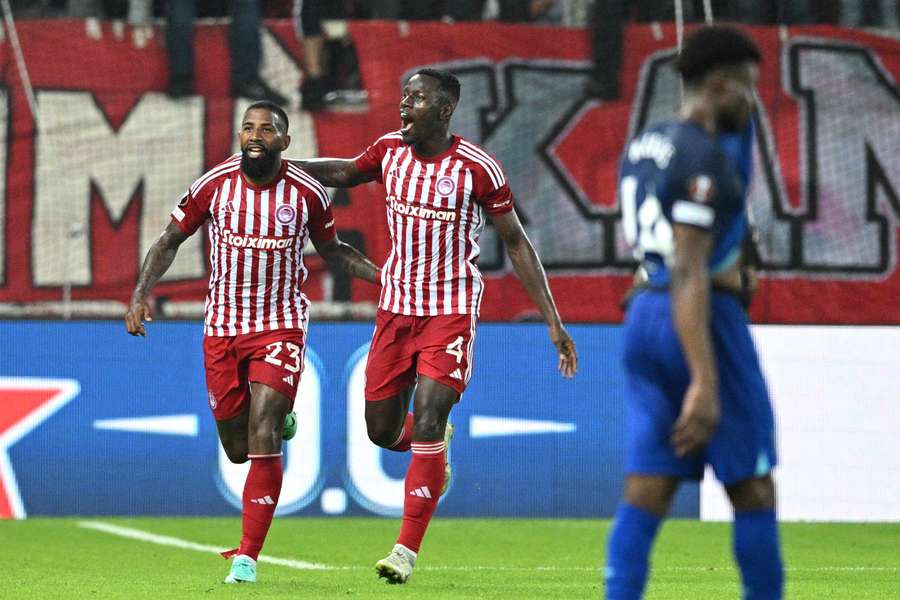 Olympiacos' Rodinei and Mady Camara celebrate after Angelo Ogbonna scored an own goal for West Ham