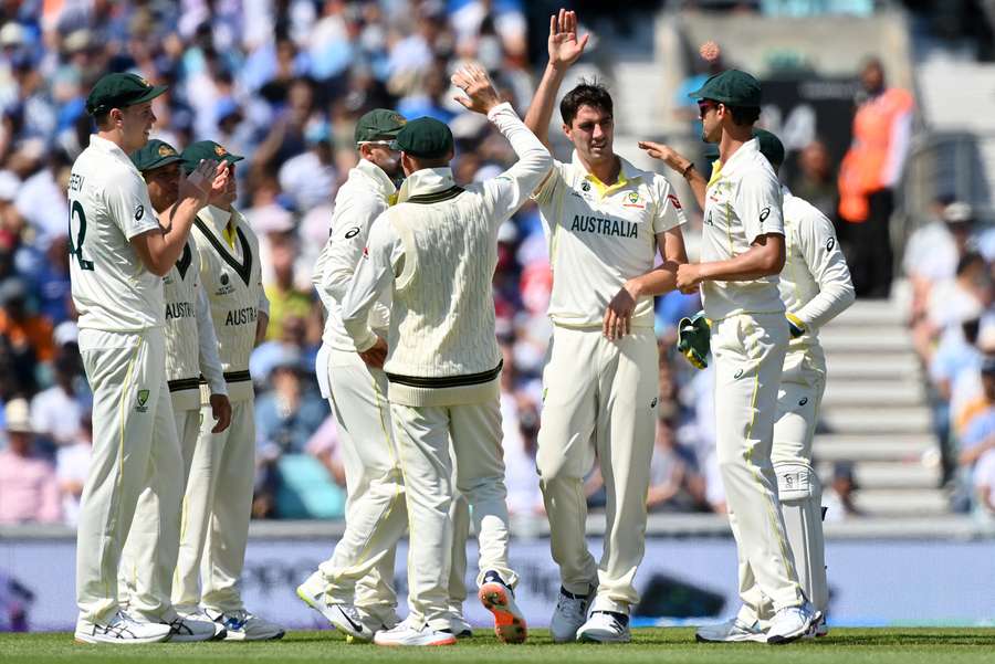 Australia celebrate Cummins dismissing Rohit