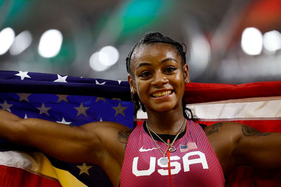 Sha'Carri Richardson wrapped in the US flag after winning the 100m final