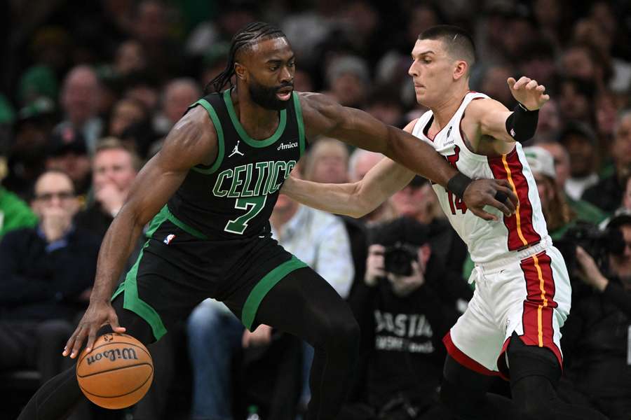 Jaylen Brown of the Boston Celtics dribbles the ball to the basket against Tyler Herro of the Miami Heat