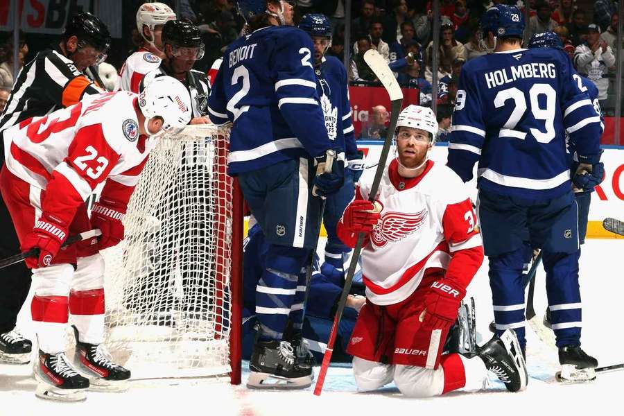 JT Compher, centre, of Detroit fails to get the puck in the Toronto net