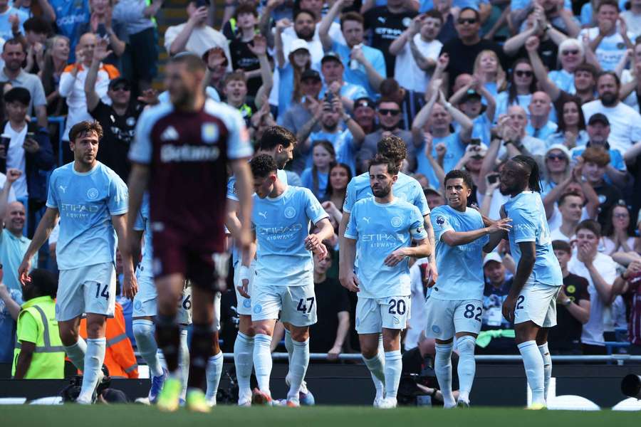 Rico Lewis celebrates with Man City teammates
