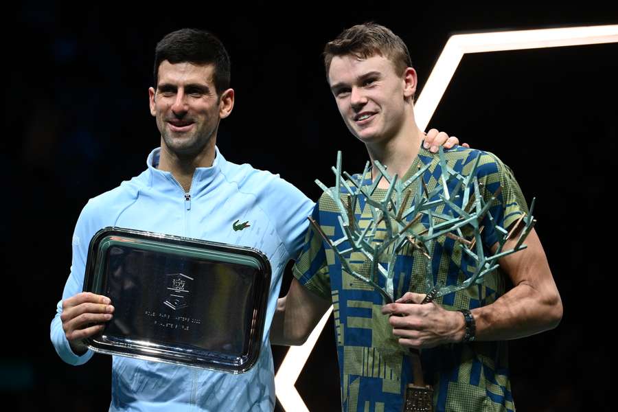 The two players pose with their respective trophies