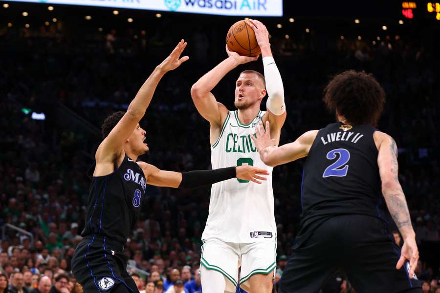 Josh Green of the Dallas Mavericks defends against Kristaps Porzingis of the Boston Celtics