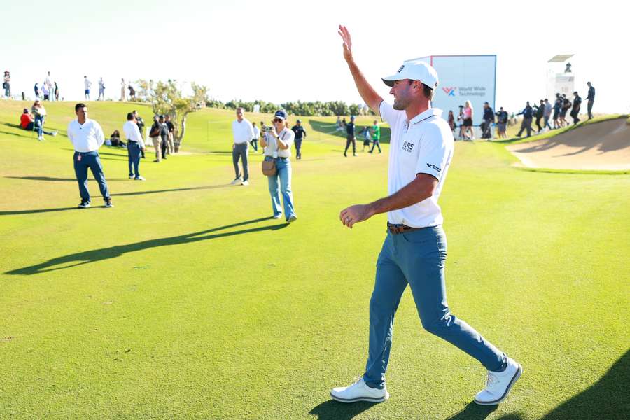 Austin Eckroat of the United States walks on the 18th green for the trophy ceremony after winning the World Wide Technology championship