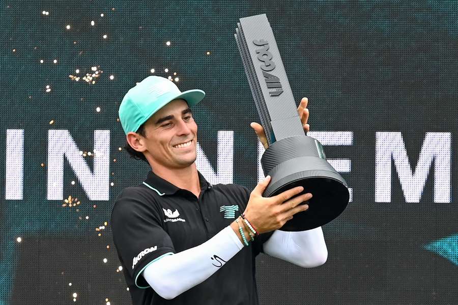 Joaquin Niemann lifts the trophy after winning the final round of LIV Golf Singapore