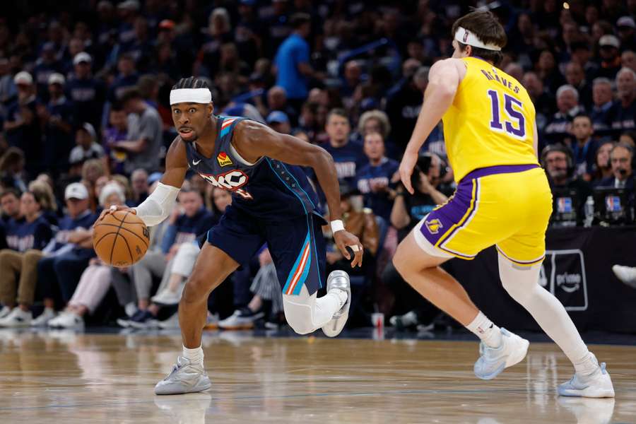Oklahoma City Thunder guard Shai Gilgeous-Alexander drives down the court against Los Angeles Lakers guard Austin Reaves