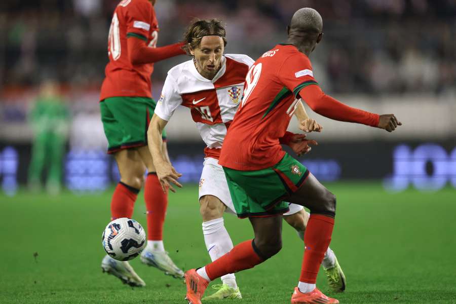 Croatia's Luka Modric fights for the ball with Portugal's Nuno Mendes