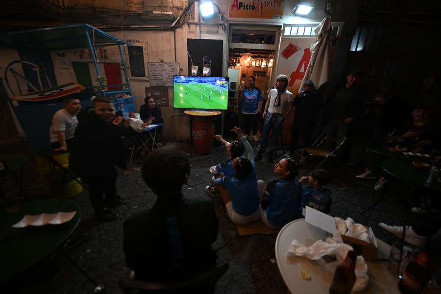 Napoli fans in a deserted Quartiere Spagnoli district in Naples watch Lazio beat Sassuolo