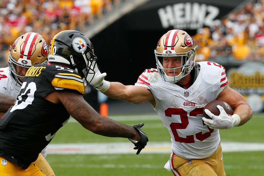 Christian McCaffrey #23 of the San Francisco 49ers runs the ball against Elandon Roberts #50 of the Pittsburgh Steelers 