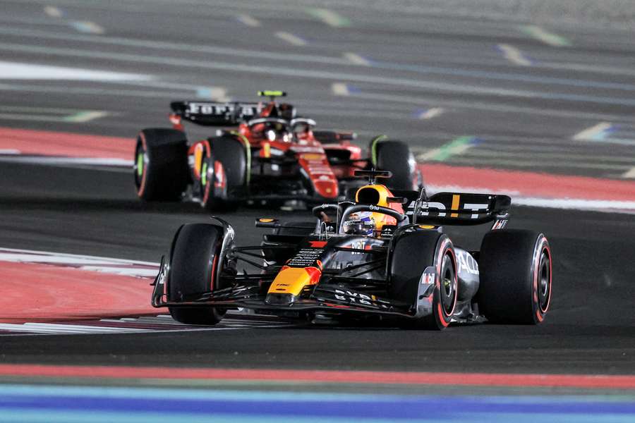 Red Bull Racing's Dutch driver Max Verstappen (foreground) drives ahead of Ferrari's Spanish driver Carlos Sainz Jr