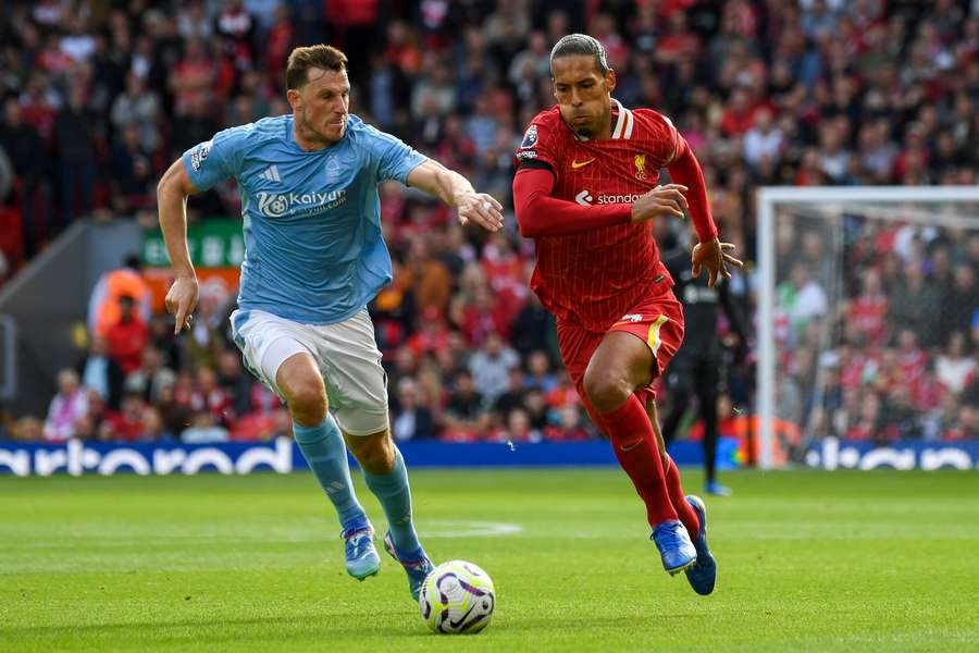 Van Dijk (R) in action for Liverpool