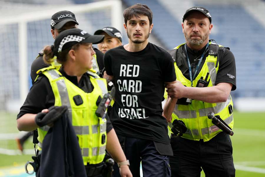 Scotland v Israel delayed as protestor chains themself to goal