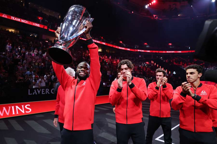 Frances Tiafoe leads Team World around the arena as they celebrate with the Laver Cup trophy