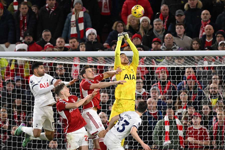 Tottenham Hotspur's Italian goalkeeper #13 Guglielmo Vicario punches the ball clear