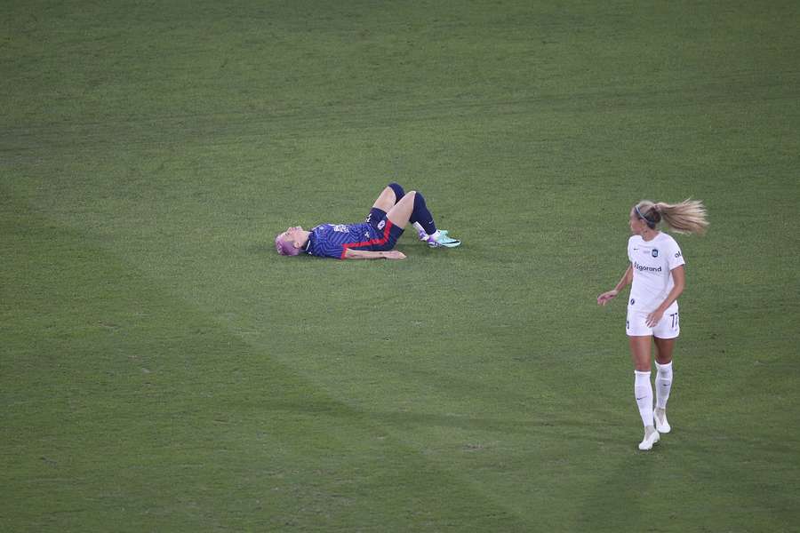 OL Reign forward Megan Rapinoe lays on the pitch following an injury in the opening minutes against Gotham FC