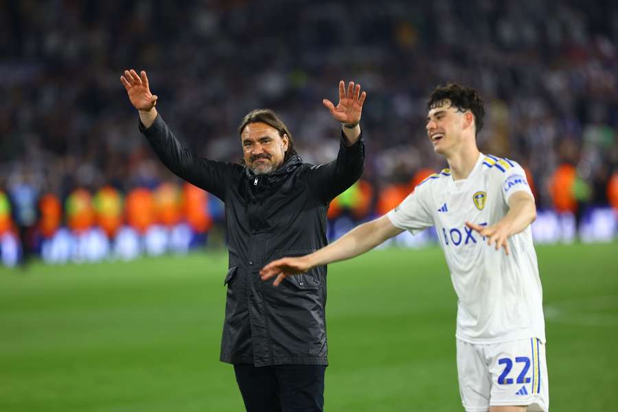 Leeds manager Daniel Farke applauds the fans with Archie Gray