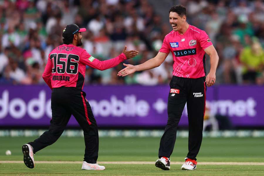 Ben Dwarshuis celebrates one of his four wickets with Babar Azam. Ben Dwarshuis celebrates one of his four wickets with Babar Azam.