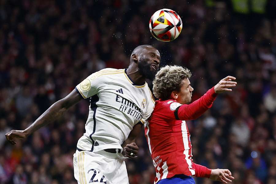 Real Madrid's Antonio Rudiger in action with Atletico Madrid's Antoine Griezmann