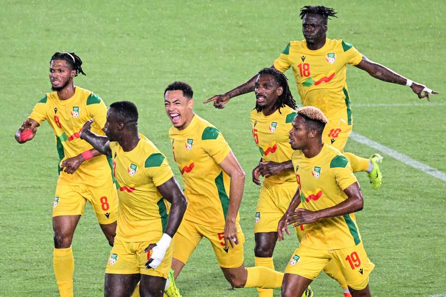 Benin's players celebrate after scoring a goal against Nigeria