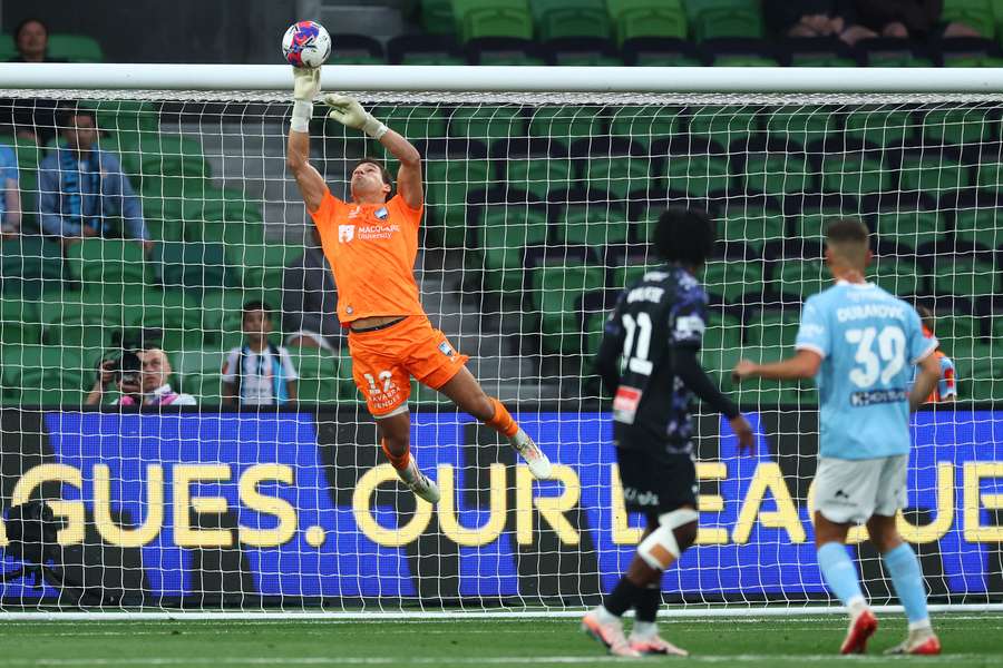 Sydney FC goalkeeper Harrison Devenish-Meares tips the ball over the bar with one of his nine saves. 