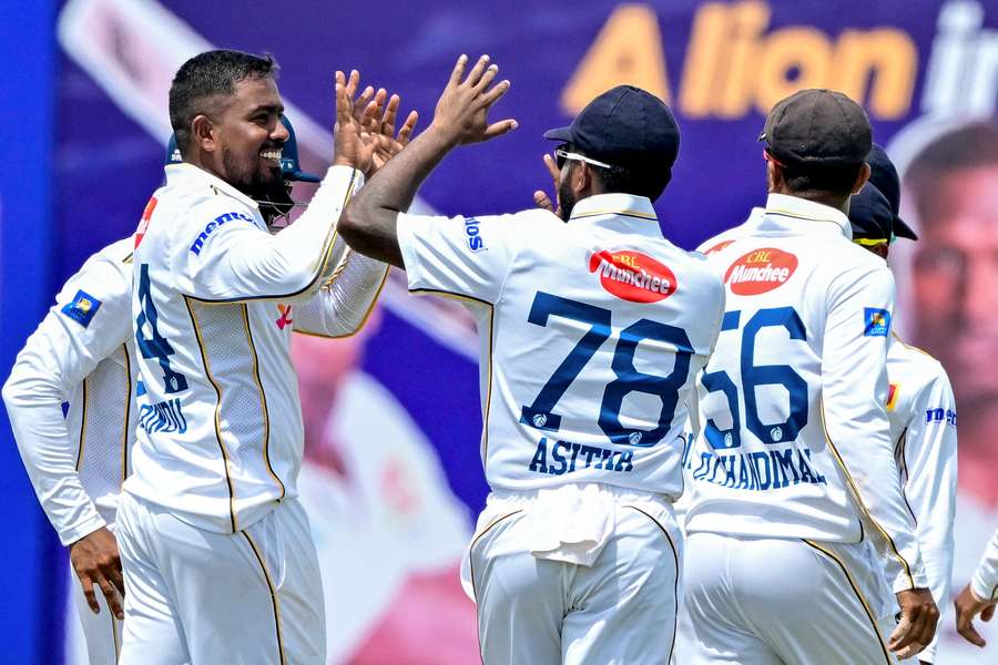 Tharindu Rathnayake (l) celebrates with Asitha Fernando after taking the wicket of Bangladesh's Mominul Haque