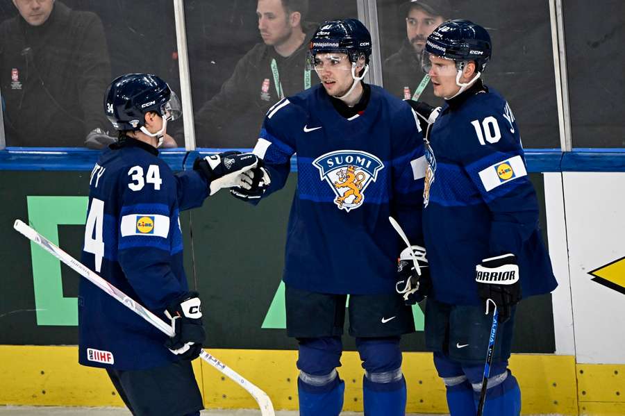 Aatu Raty (left), Ville Heinola (centre) and Henri Jokiharju after Finland's second goal