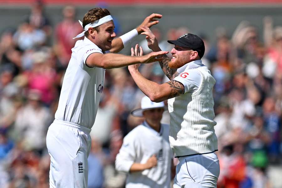 England's Stuart Broad (L) celebrates with England's captain Ben Stokes (R) after taking his 600th wicket