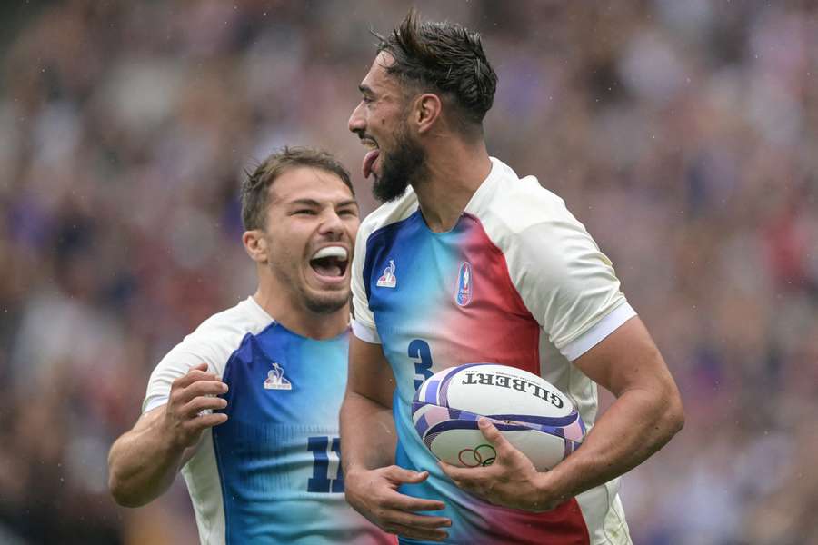 France's Rayan Rebbadj celebrates with France's Antoine Dupont (L) after scoring a try