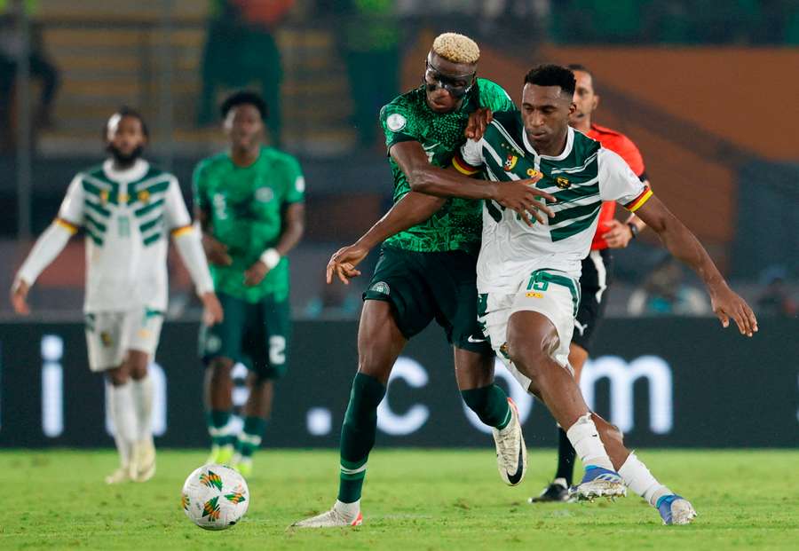 Nigeria's Victor Osimhen (L) in action with Cameroon's Oumar Gonzalez