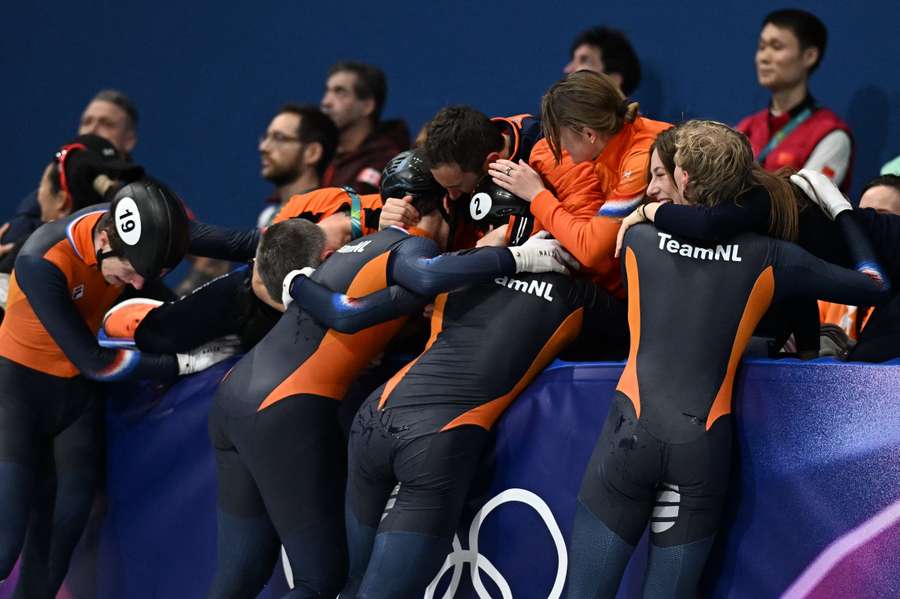 The Netherlands' Teun Boer, Melle van 't Wout, Jens van 't Wout, and Friso Emons celebrate winning the gold medal with their team and team-mates