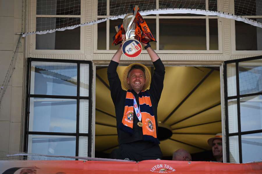 Luton Town's Welsh manager Rob Edwards lifts the Championship play-off trophy