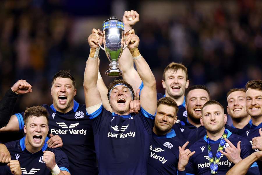 Scotland's Jamie Ritchie and teammates celebrate with the Doddie Weir Cup after the match
