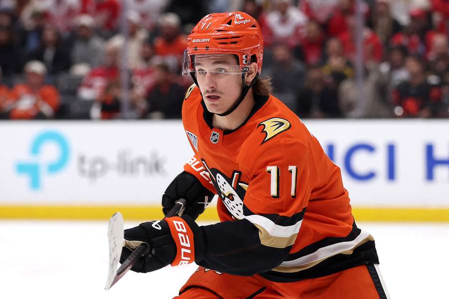 Trevor Zegras skating towards the puck during a game between the Anaheim Ducks and Detroit Red Wings