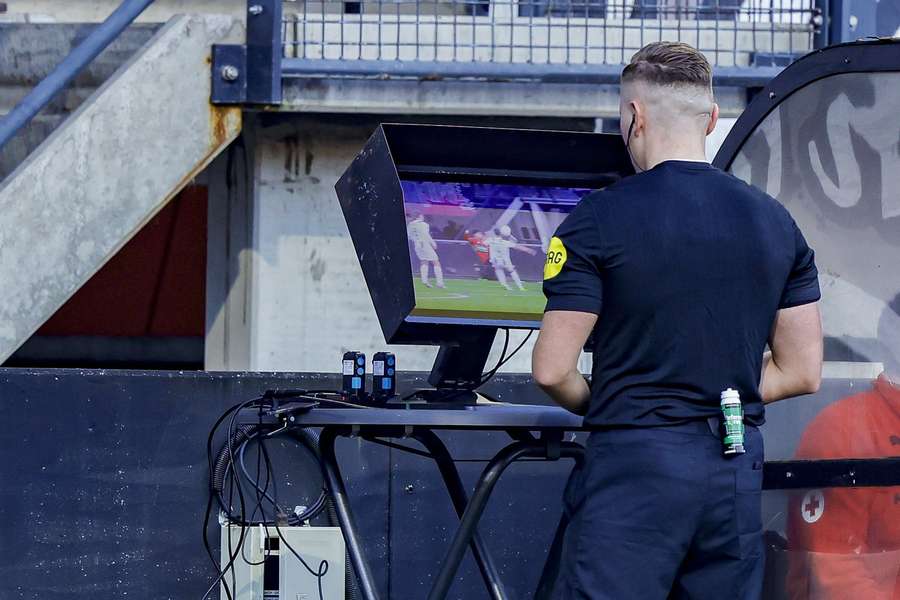 Dutch referee Martijn Vos checks the VAR screen during an Eredivisie match between NEC Nijmegen and FC Groningen