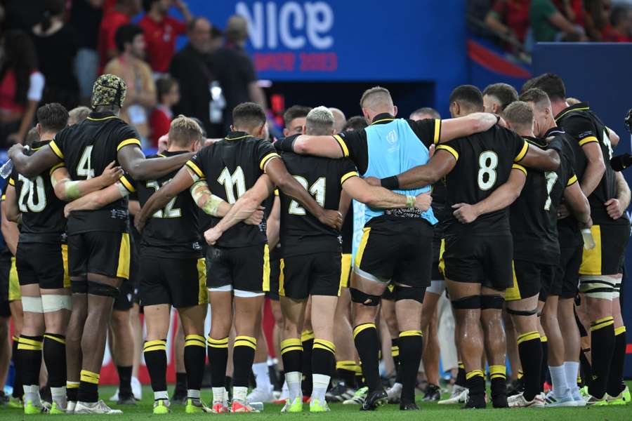 Wales' players huddle around each other