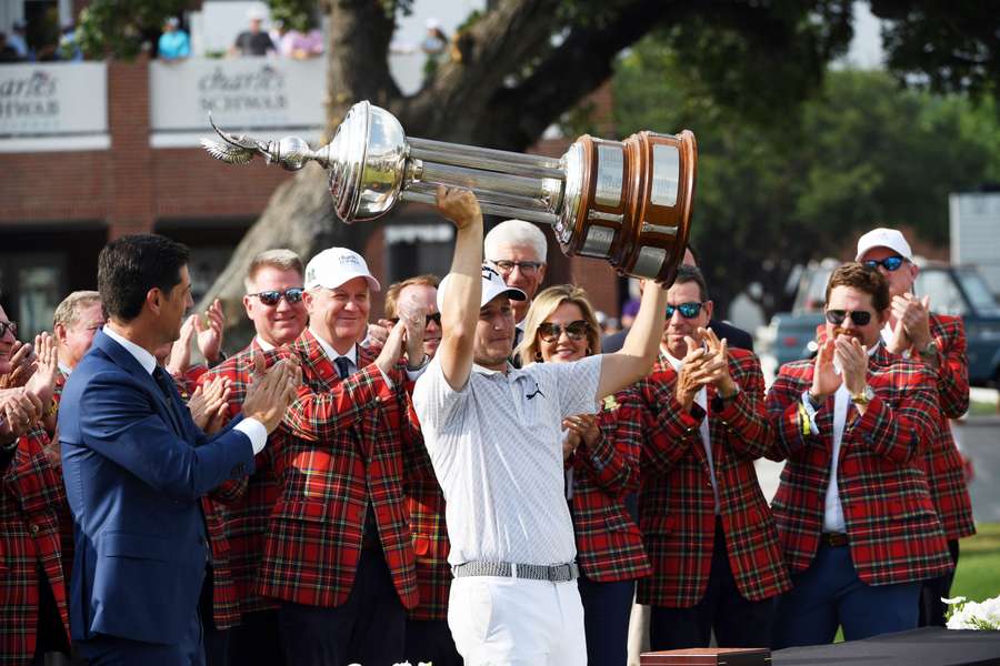 Emiliano Grillo of Argentina hoists the trophy