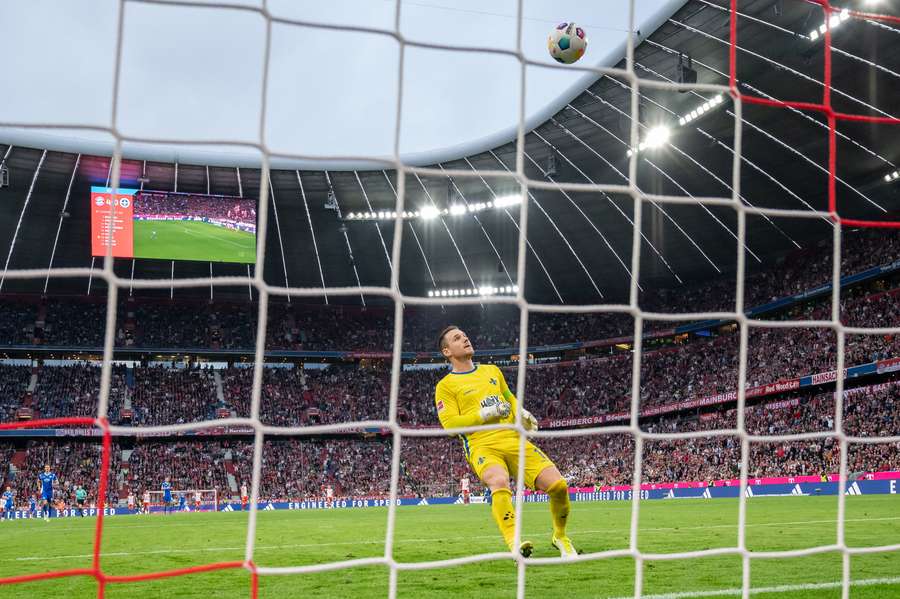 Harry Kane scores his team's fifth goal as Marcel Schuhen can only watch the ball go in