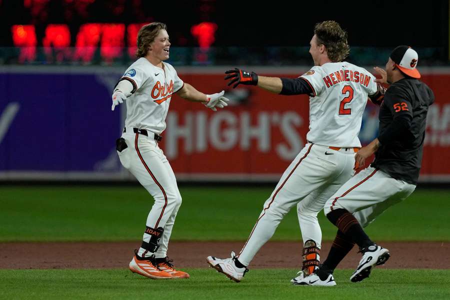 Jackson Holliday (left) celebrates with teammates after Orioles walk-off win (2025)