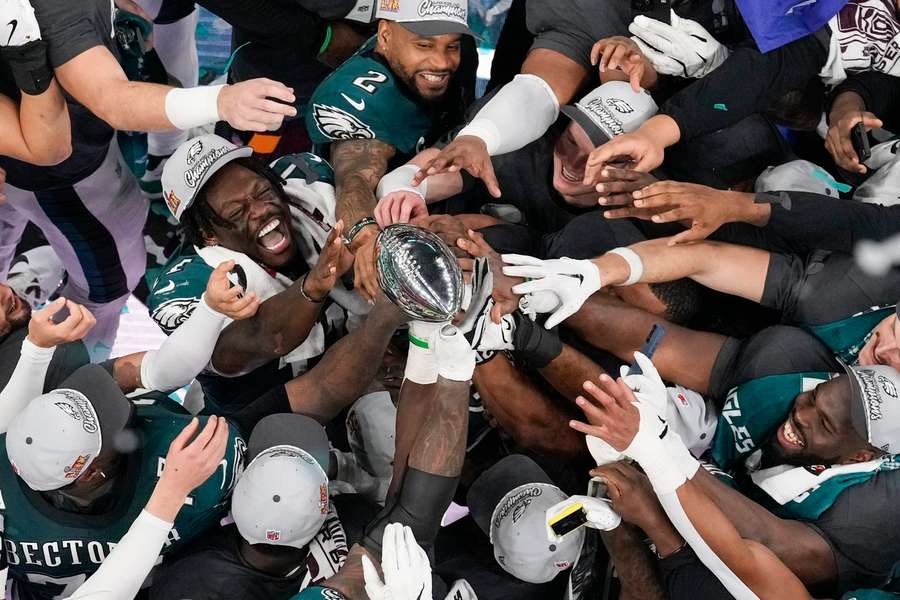 The Philadelphia Eagles celebrate with the Vince Lombardi Trophy after their team won NFL Super Bowl LIX against the Kansas City Chiefs