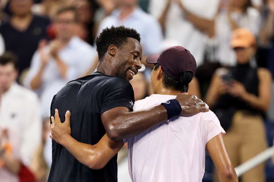 Monfils (left) congratulates Tien at the net Monfils (left) congratulates Tien at the net