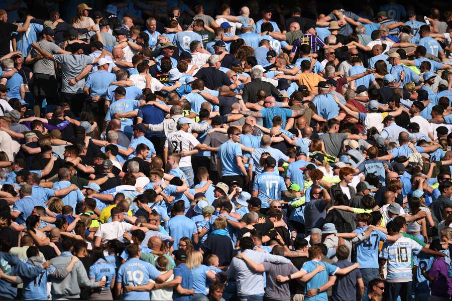 Manchester City fans do 'the Poznan' celebration during the English Premier League football match between Manchester City and Chelsea