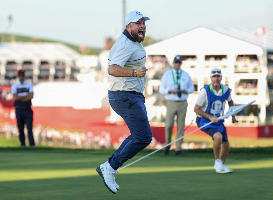 Shane Lowry of Team Europe celebrates after his putt to halve the hole and retain the Ryder Cup