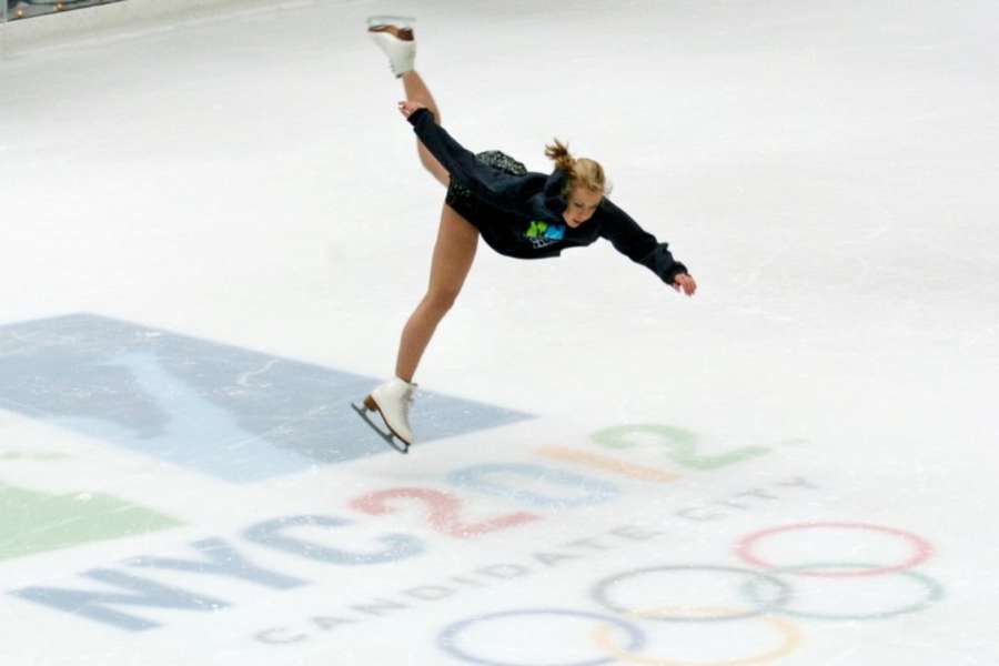 Olympic gold medalist Oksana Baiul flies above the NYC2012 logo during an exhibition in 2005