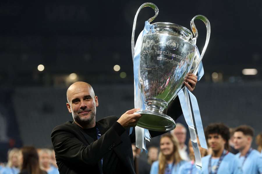 Pep Guardiola lifts the Champions League trophy after his Manchester City side won in Istanbul