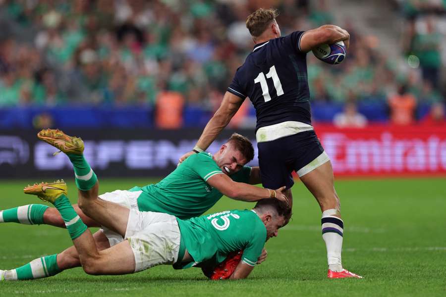 Ireland's Crowley (L) and Keenan (C) tackle Scotland's Duhan van der Merwe (R)