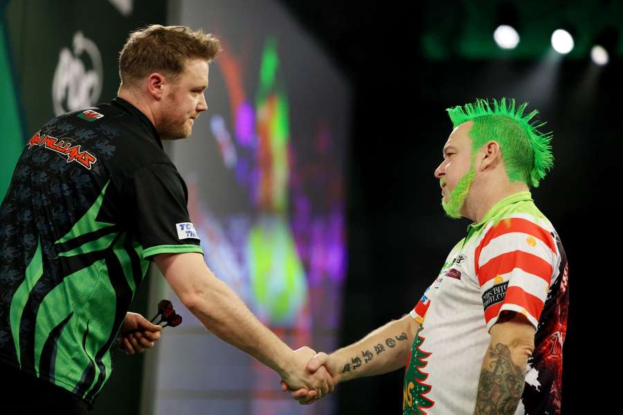 Jim Williams shakes hands with Peter Wright after winning the round 2 match against Peter Wright