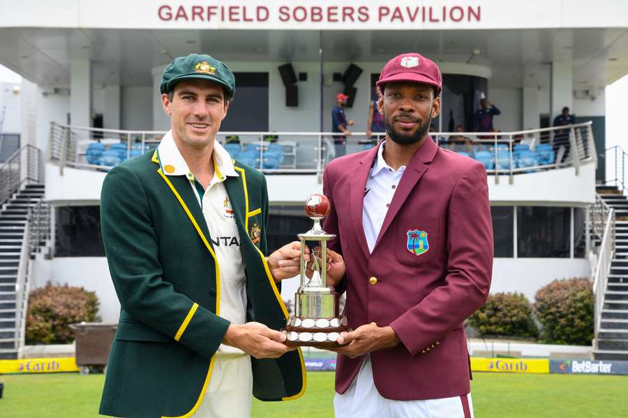 Pat Cummins and Roston Chase pose with the Frank Worrell Trophy ahead of their three-Test series.