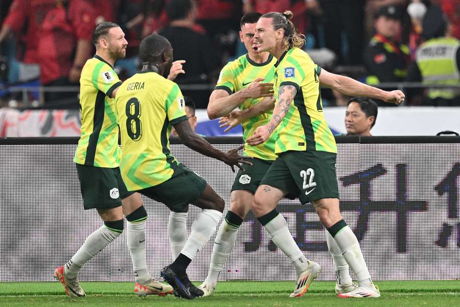 Australia's Jackson Irvine (right) celebrates with teammates after scoring against China