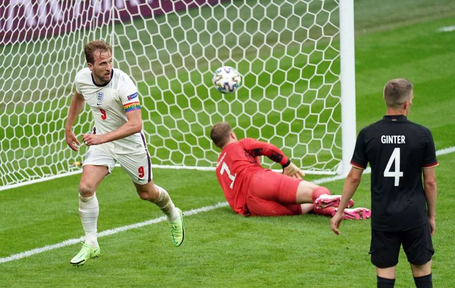 Kane (L) scores against Germany